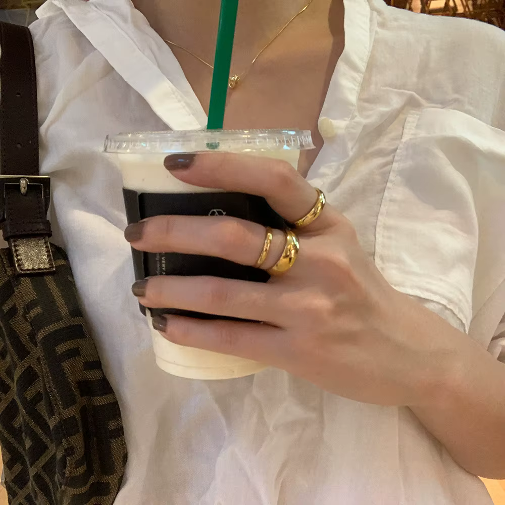 Woman wearing stacked gold rings